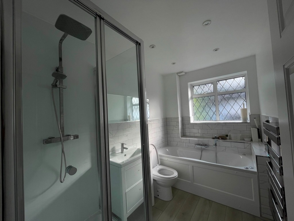 Luxury Woodstock interior bathroom design with walk-in rainfall shower and deep bath
